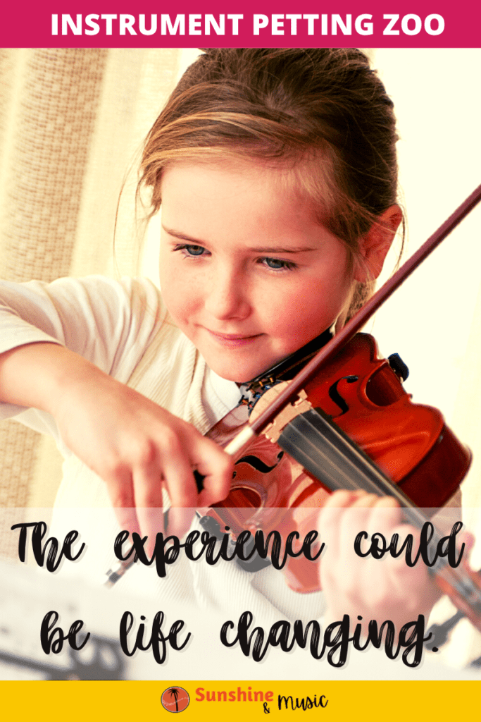 child trying a violin at an instrument petting zoo